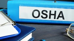 blue binder that is labeled OSHA on desk with other office supplies blue binder that is labeled OSHA on desk with other office supplies