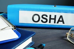 blue binder that is labeled OSHA on desk with other office supplies blue binder that is labeled OSHA on desk with other office supplies