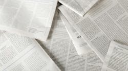 newspapers scattered on a flat surface newspapers scattered on a flat surface