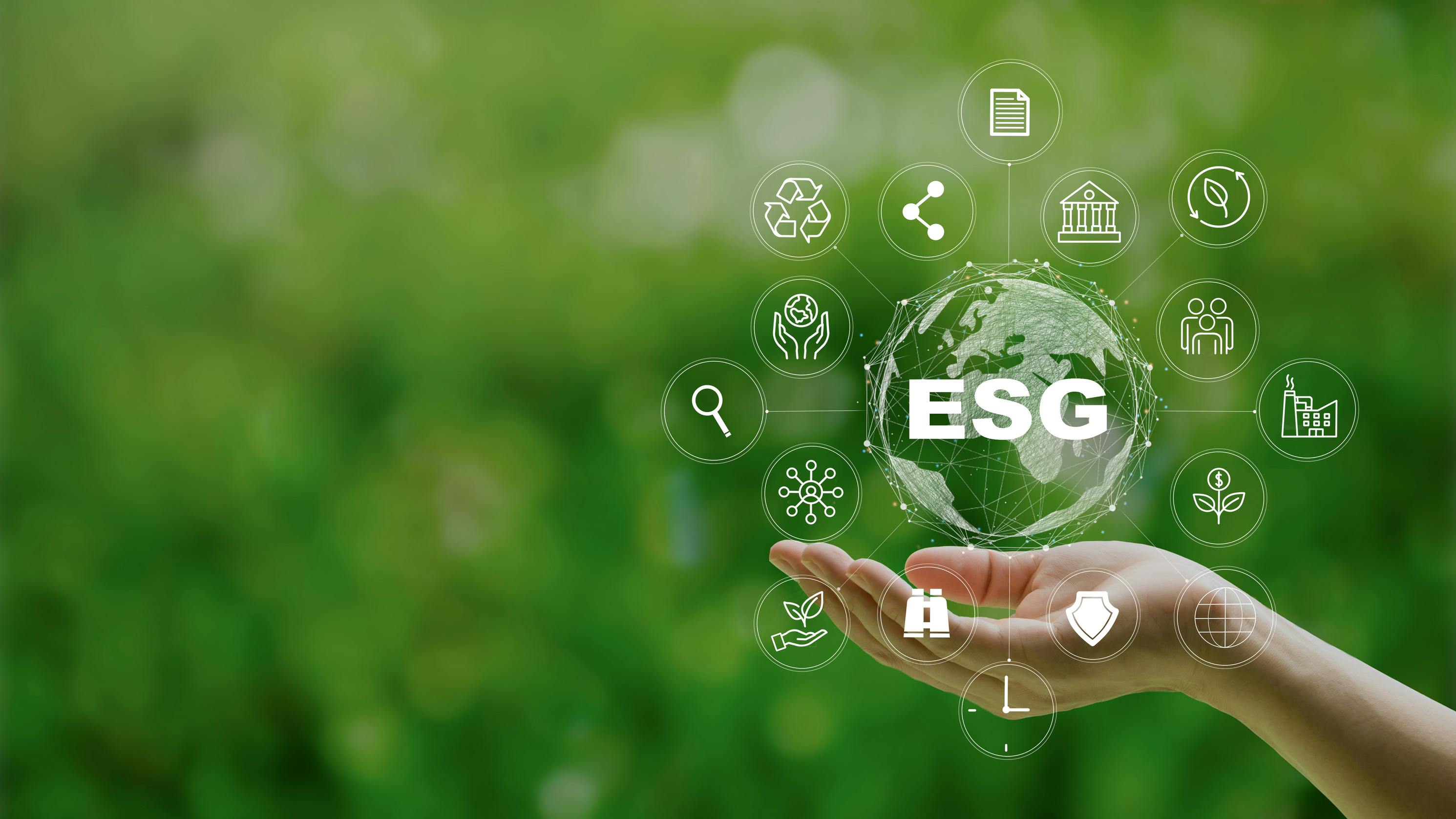 hand outstretched against green backdrop representing concept of environmental, social and governance (ESG)
