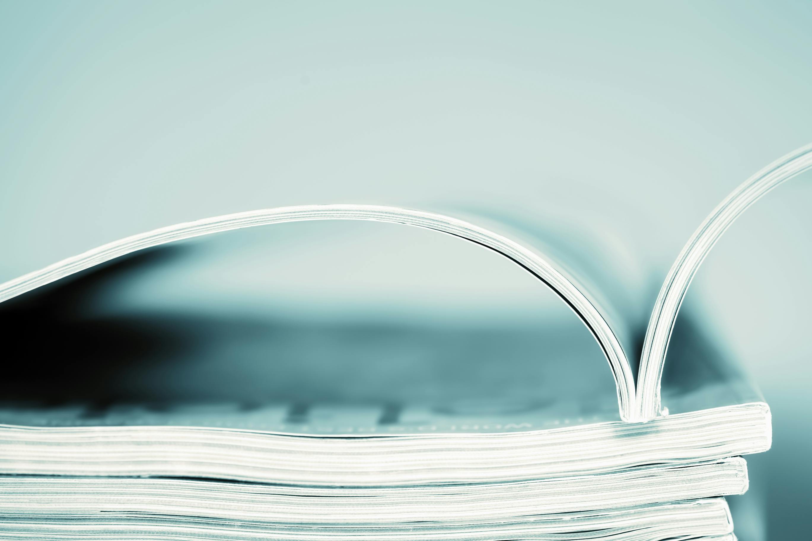 picture of a stack of magazines with the one one top opened up