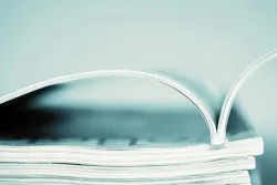 picture of a stack of magazines with the one one top opened up picture of a stack of magazines with the one one top opened up