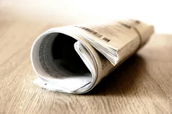 picture of rolled up newspaper on table picture of rolled up newspaper on table