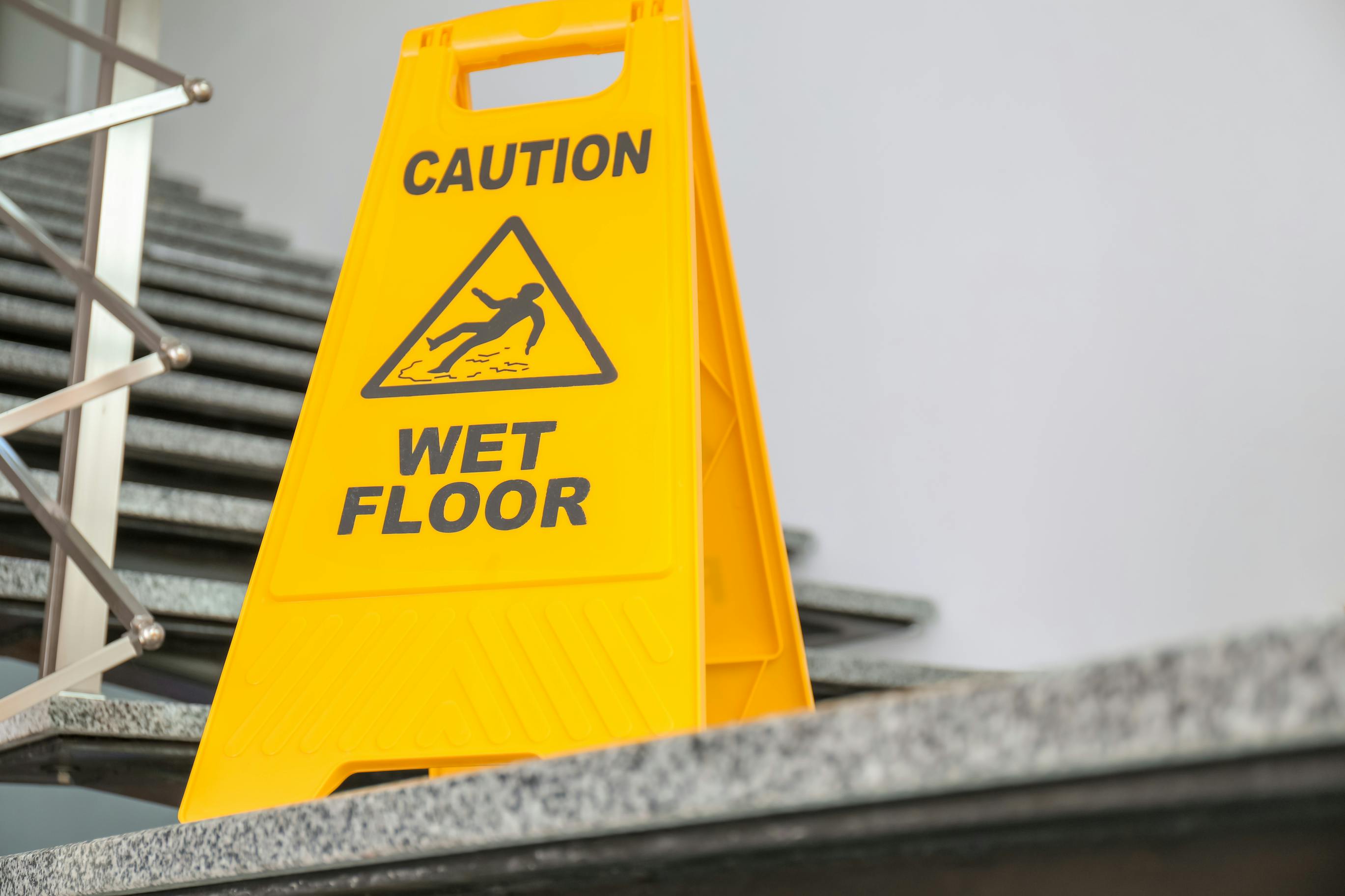 picture of caution wet floor sign in front of stairs
