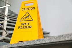 picture of caution wet floor sign in front of stairs
