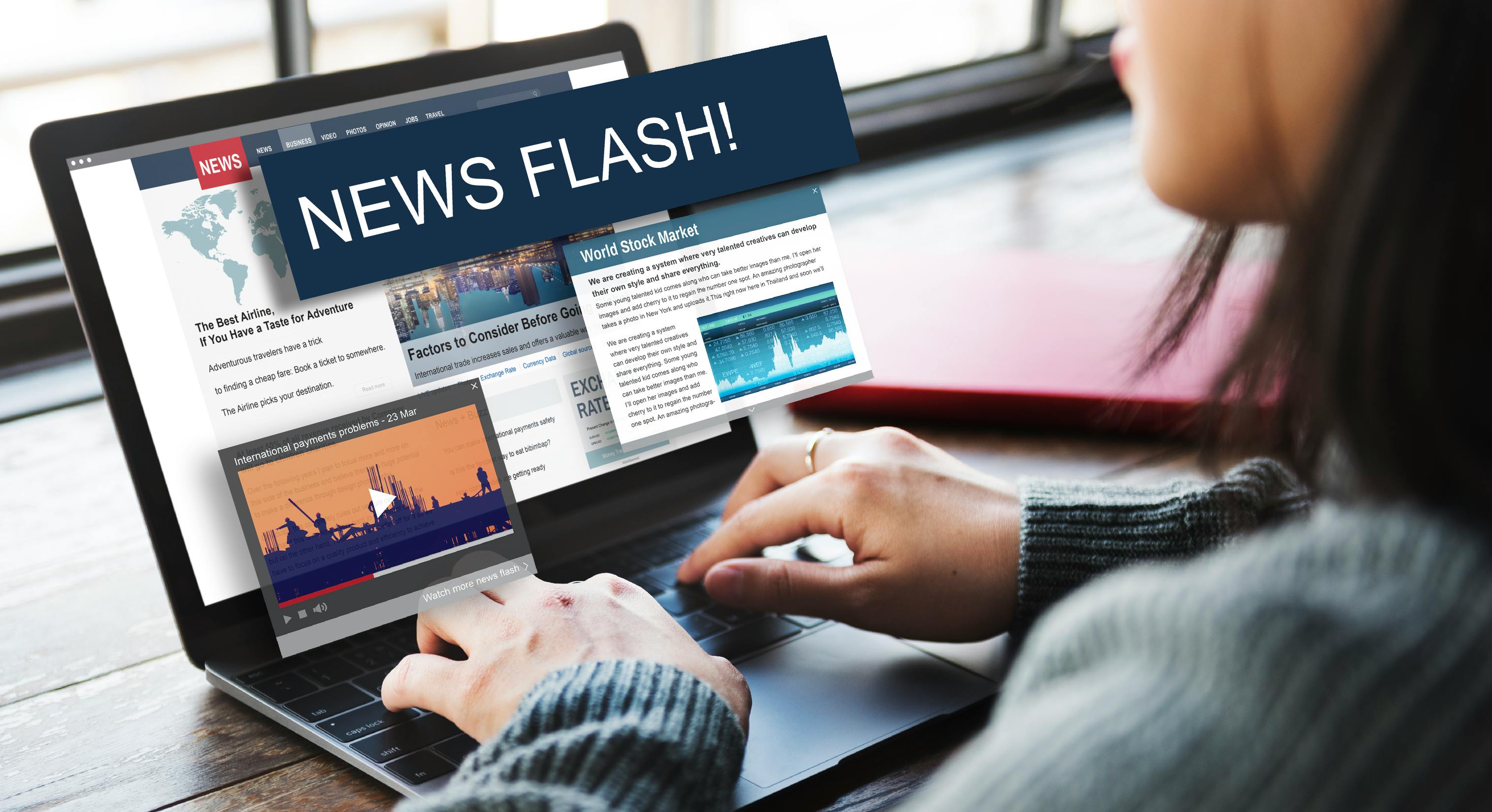 picture of woman looking at laptop that says News Flash and shows other news headlines