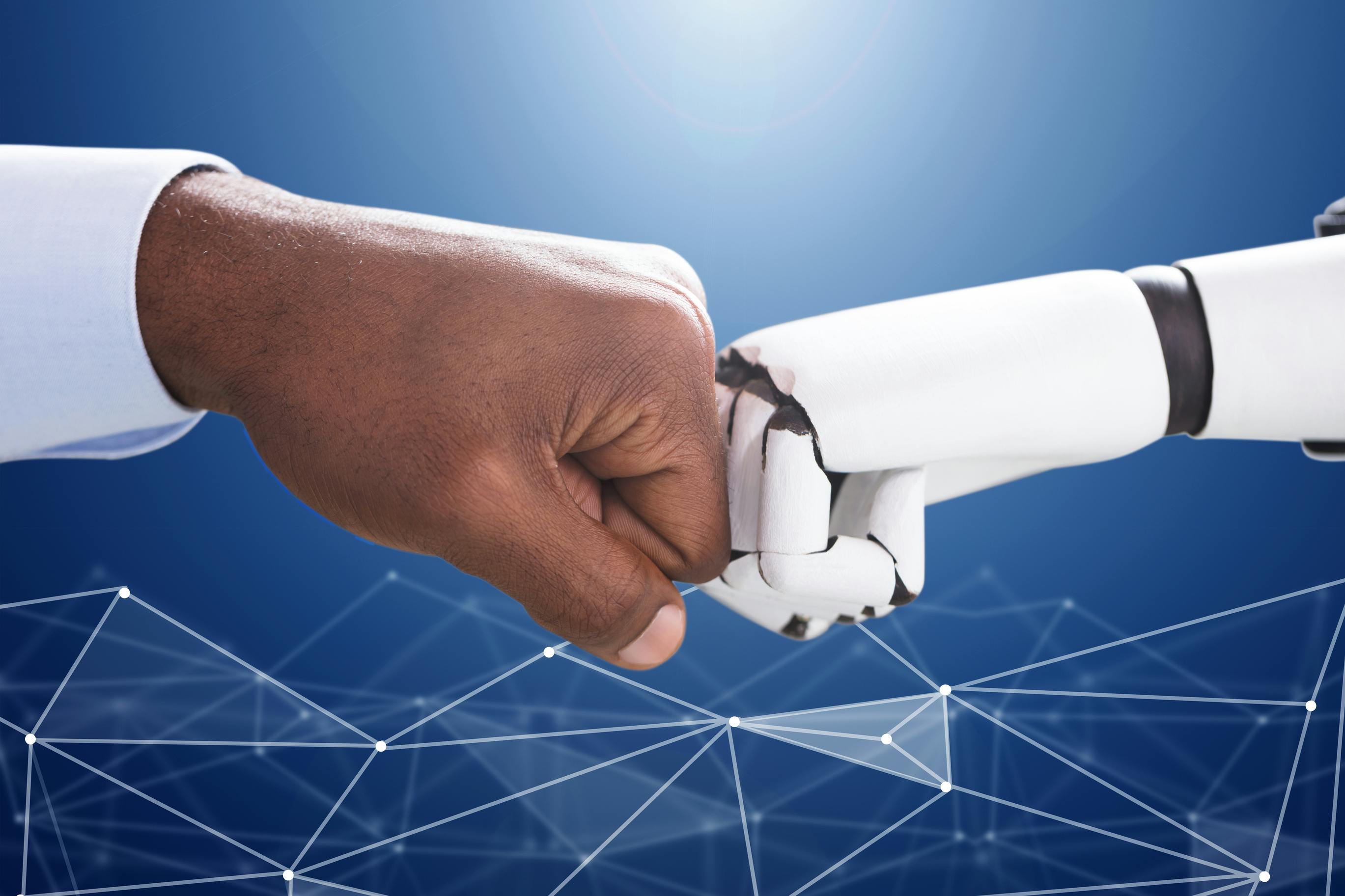 illustration of man and robot bumping fists to indicate man's trust in technology and artificial intelligence